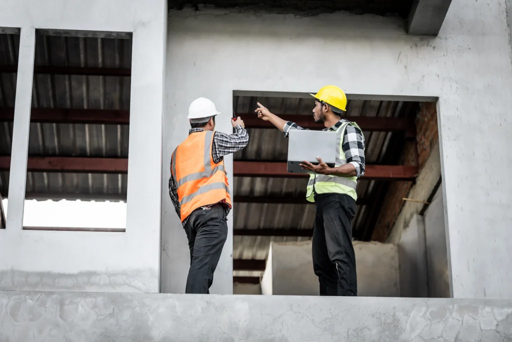 2 construction engineers observing a building be built
