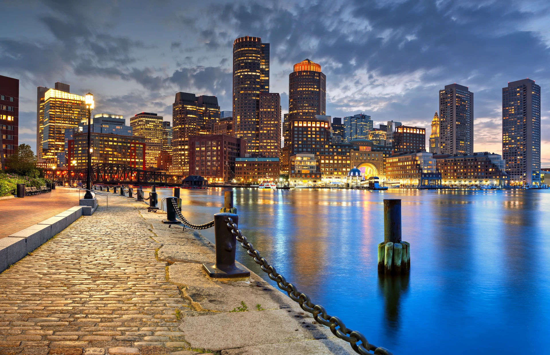city of Boston at night from a view from the harbor