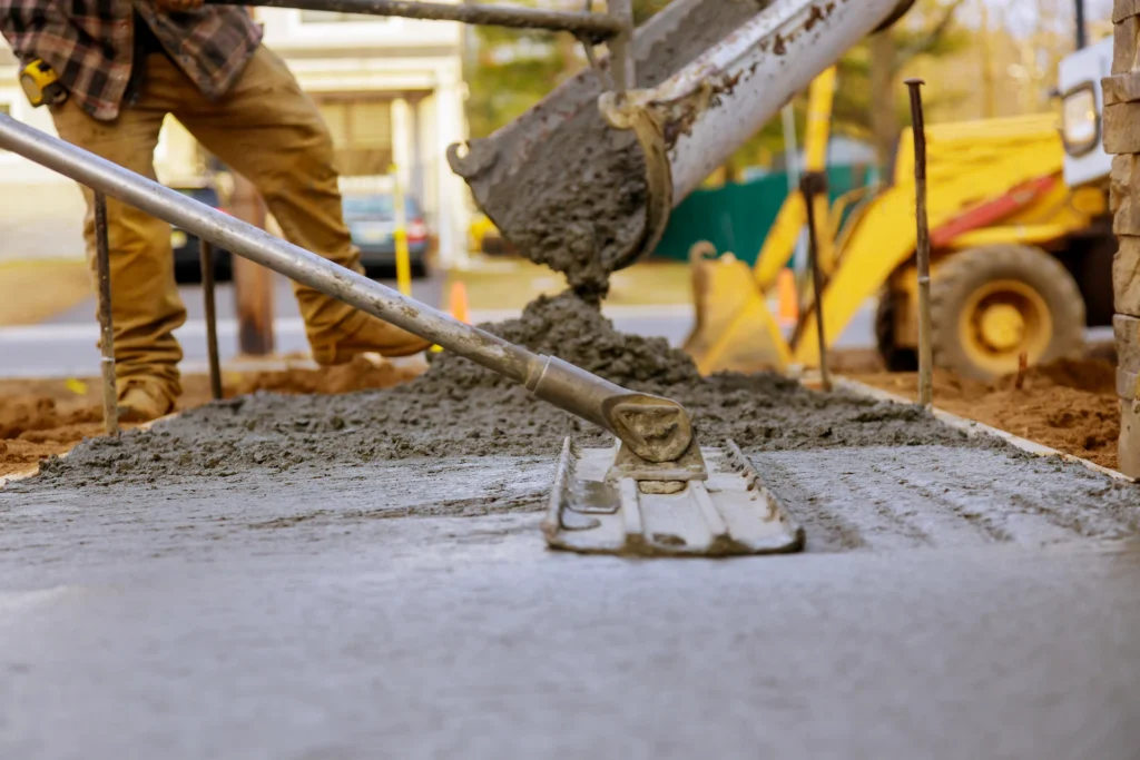 masonry worker smoothing fresh cement