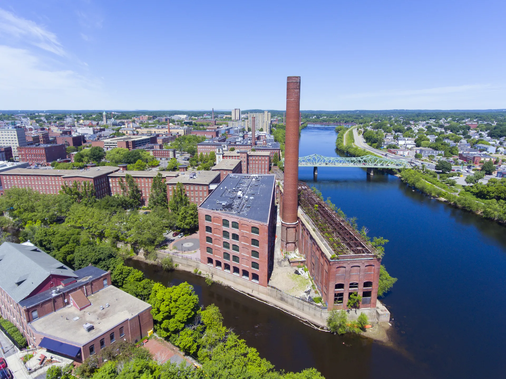 old mill building in need of waterproofing near a river edge