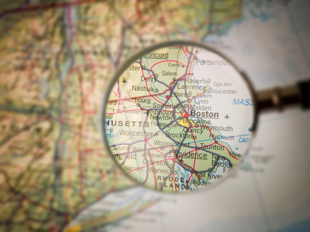 magnifying glass looking over a map of Boston Massachusetts