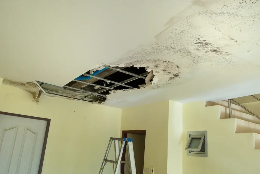 water damaged ceiling in a yellow room