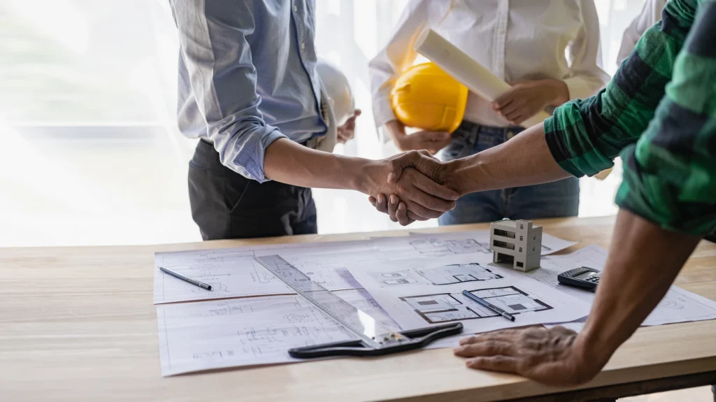 contractor and business owner shaking hands