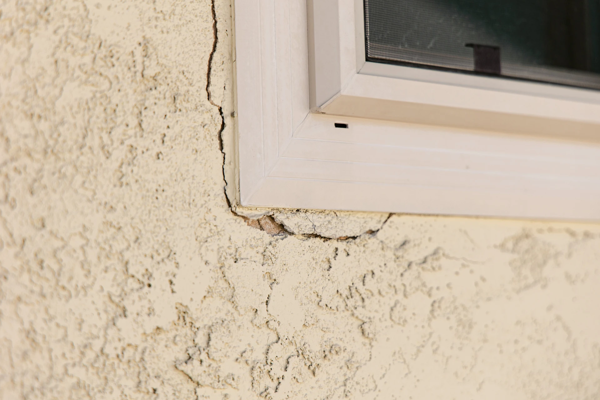 A cracked exterior wall of a residential home